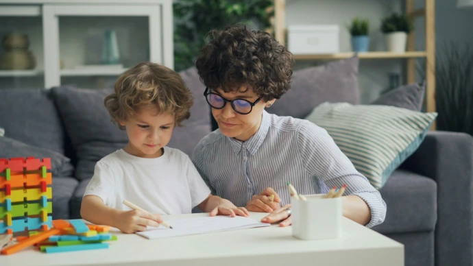 a woman and a child are sitting at a table